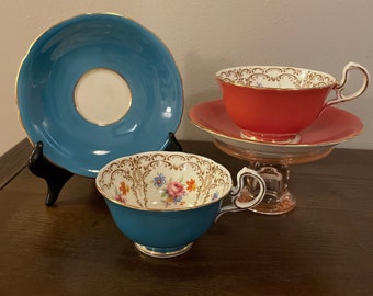 Vintage Aynsley Tea cup and saucer. Set of 2. A beautiful turquoise blue and a gorgeous coral both with a floral design inside the cup.