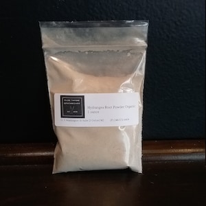 May include: A small resealable plastic bag containing a light brown powder labeled "Hydrangea Root Powder Organic 1 ounce" with the company name and contact information printed on the label.