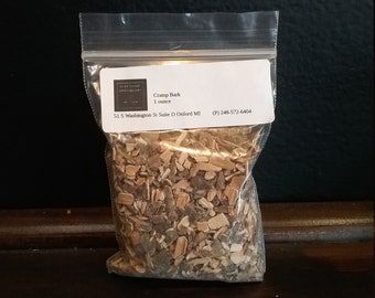 May include: A clear plastic bag containing a one ounce package of dried cramp bark. The package has a label that reads "Cramp Bark 1 ounce" and includes the business name "Old Thyme Apothecary" and contact information.