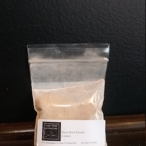 May include: A small clear plastic bag containing a beige powder labeled "Yucca Root Powder 1 ounce" with the company name "Olde Thyme Apothecary" and contact information.