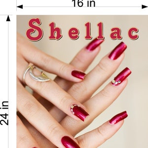 May include: A close-up of a hand with red nail polish and rhinestones. The text "Shellac Manicure 24" is visible at the bottom of the image.