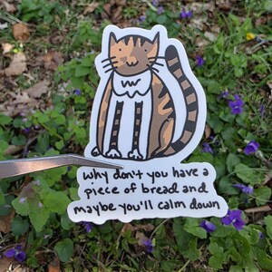 Vinylklistermärke med stansad katt och en bit bröd