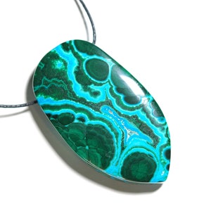 May include: A green and blue malachite pendant on a black cord. The pendant is a teardrop shape with a smooth, polished surface.