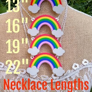 May include: Four rainbow necklaces with clouds on a mannequin. The necklaces are available in four lengths: 13 inches, 16 inches, 19 inches, and 22 inches. The text "Necklace Lengths" is displayed below the necklaces.