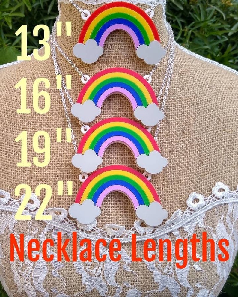 May include: Four rainbow necklaces with clouds on a mannequin. The necklaces are available in four lengths: 13 inches, 16 inches, 19 inches, and 22 inches. The text "Necklace Lengths" is displayed below the necklaces.
