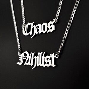 May include: Two silver necklaces with the words "Chaos" and "Philist" in a gothic font.