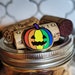 A reviewed Queer-o-Lantern (LGBTQIA+ pride) hard enamel pin