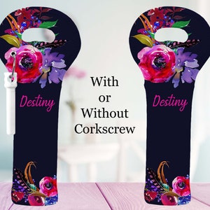 May include: A navy blue wine bottle bag with a floral design in shades of red, purple, and gold. The bag has a handle at the top and the word "Destiny" in pink. The bag is shown with and without a white corkscrew.