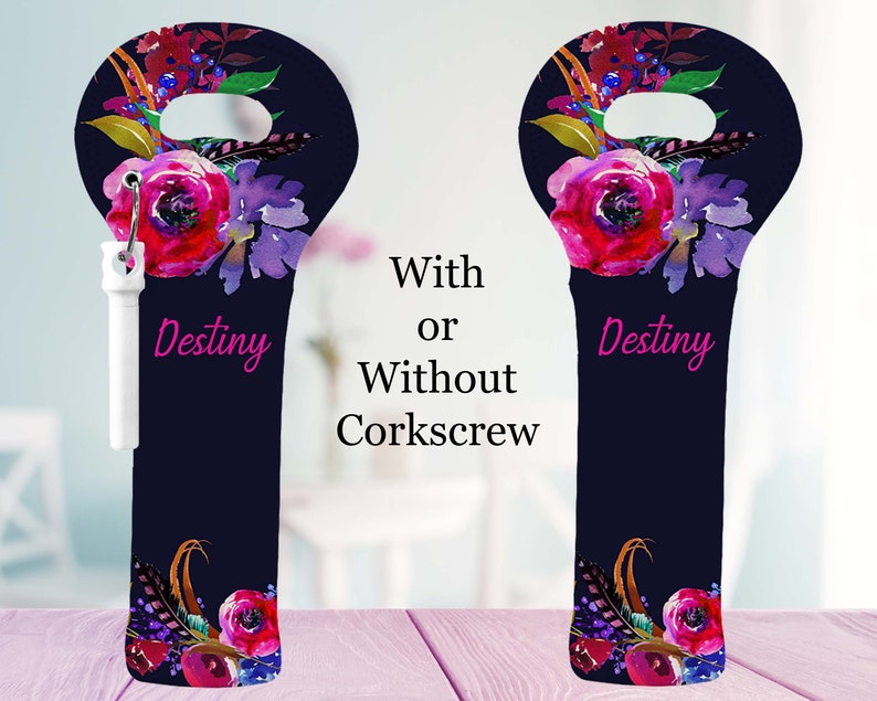 May include: A navy blue wine bottle bag with a floral design in shades of red, purple, and gold. The bag has a handle at the top and the word "Destiny" in pink. The bag is shown with and without a white corkscrew.