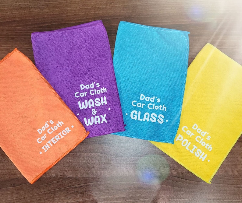 May include: Four microfiber cloths with different colored borders and text. The cloths are labeled "Dad's Car Cloth" with different uses: "Interior", "Wash & Wax", "Glass", and "Polish".