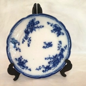 May include: A blue and white porcelain plate with a floral design. The plate has a scalloped edge and is in excellent condition.