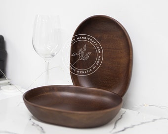 May include: Two brown wooden oval serving trays. The larger tray has the text "VIETNAM MADE IN VIETNAM HANDICRAFT.COM" printed on the bottom.