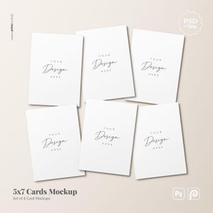 May include: A set of six blank white rectangular cards arranged in a grid, each featuring the placeholder text "YOUR DESIGN HERE" in a thin black script font. The cards are presented as a digital mockup for 5x7 inch stationery designs.