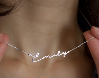 May include: A silver necklace with the name "Emily" written in cursive script.