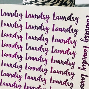 May include: A sheet of white sticker paper with the word "Laundry" repeated 12 times in a purple gradient font.