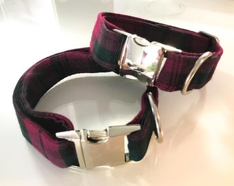 May include: Two red and green plaid dog collars with silver buckles and D-rings.