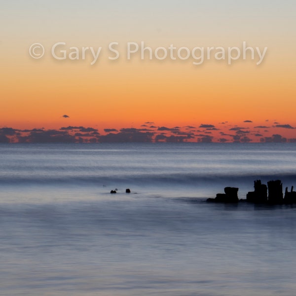 Photograph Print of Pier Pilings In The Ocean During a Sunrise On Freeman Park's Carolina Beach, North Carolina