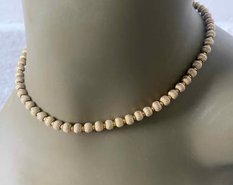 Elegant vintage gold tone beaded necklace with textured gold beads