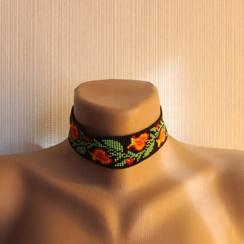 Wide beaded choker with a traditional Slavic pattern Orange flowers ethnic amulets Black background boho jewelry