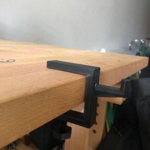 Coat hanger for table or adjustable shelf
