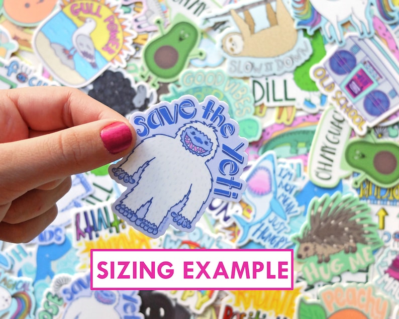 May include: A white yeti sticker with blue accents and the text "Save the Yeti!" on a blue background. The sticker is being held by a hand.