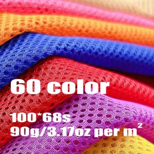 May include: A stack of layered mesh fabric in vibrant colors including orange, blue, red, purple, and yellow. The text 60 color, 100*68s, and 90g/3.17oz per m2 is printed in white over the fabric layers, highlighting the material texture.