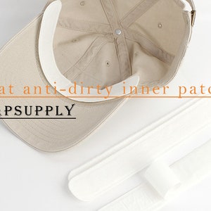 May include: A beige baseball cap with a white inner patch to prevent sweat stains. The patch is labeled "Hat anti-dirty inner patch" and "CAPSUPPLY".
