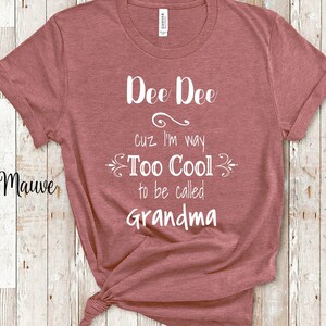 May include: Mauve t-shirt with white text that reads "Dee Dee cuz I'm way Too Cool to be called Grandma".