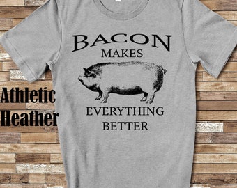 May include: Gray t-shirt with a black and white illustration of a pig and the text "Bacon Makes Everything Better".