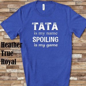 May include: A royal blue t-shirt with white text that reads "TATA is my name SPOILING is my game".