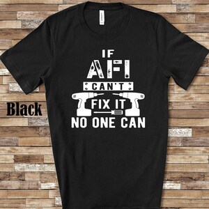 May include: Black t-shirt with a white graphic that says "If I can't fix it, no one can." The graphic also includes two white images of power drills.