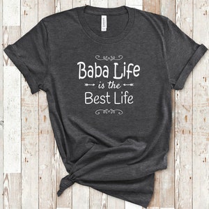 May include: A dark grey t-shirt with the text "Baba Life is the Best Life" printed in white on the front.