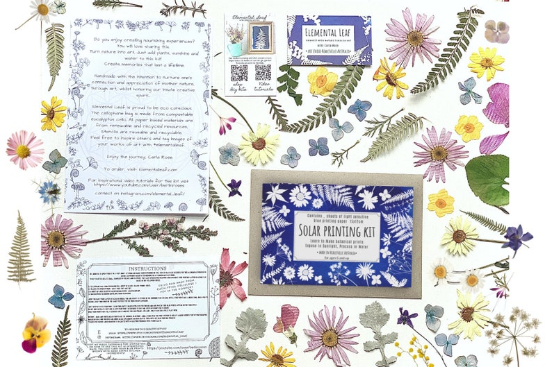 May include: A craft kit for making solar prints using pressed flowers and leaves. The kit includes a variety of dried botanicals, a sheet of solar printing paper, and instructions. The kit is packaged in a brown envelope with a blue and white design featuring the text "Solar Printing Kit".