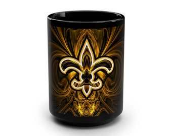 May include: Black ceramic mug featuring a gold and white fleur-de-lis design. The fleur-de-lis is the focal point, set against a swirling gold background. The mug is cylindrical and suitable for hot or cold beverages.
