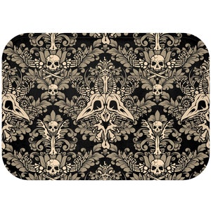 May include: A black and beige patterned tray with a skull and crossbones design. The tray has a damask pattern with floral elements and skeletal motifs.