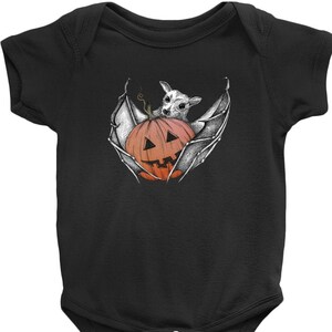May include: A black baby onesie with a white illustration of a bat holding a jack-o'-lantern.