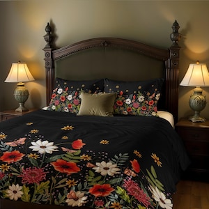 May include: Black duvet cover with a floral print featuring red poppies, white daisies, and green leaves. The duvet cover is on a bed with a dark headboard and two matching pillowcases.