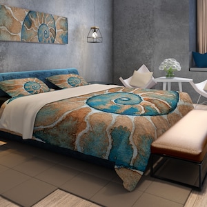May include: A teal and brown bedding set with a nautilus shell design. The bedding is on a bed with two pillows and a brown leather bench at the foot of the bed.