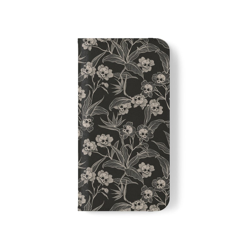 May include: Black phone case with a white floral pattern featuring skulls.
