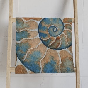 May include: A watercolor painting of a nautilus shell with blue and brown tones. The shell is spiraled and has a textured surface.