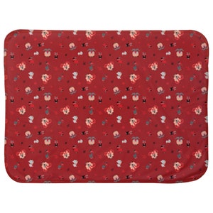 May include: Red fleece baby blanket with a repeating pattern of white sheep wearing red and white hats and holding red and white candy canes.