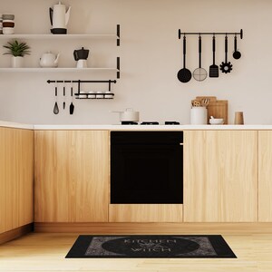 May include: Black and white kitchen rug with the text "Kitchen Witch" in a circle with a witch's hat and broom inside the circle.