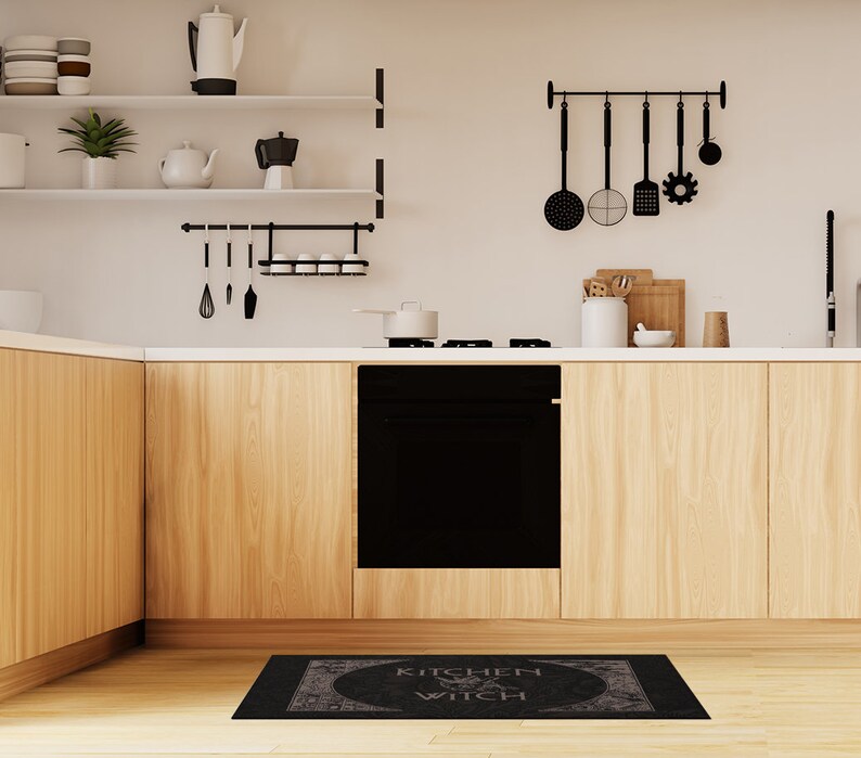 May include: Black and white kitchen rug with the text "Kitchen Witch" in a circle with a witch's hat and broom inside the circle.