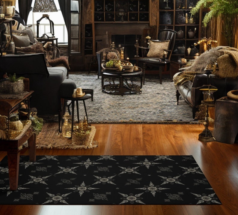 May include: Black and white patterned area rug with a geometric design. The rug is laid out on a hardwood floor in a living room setting.