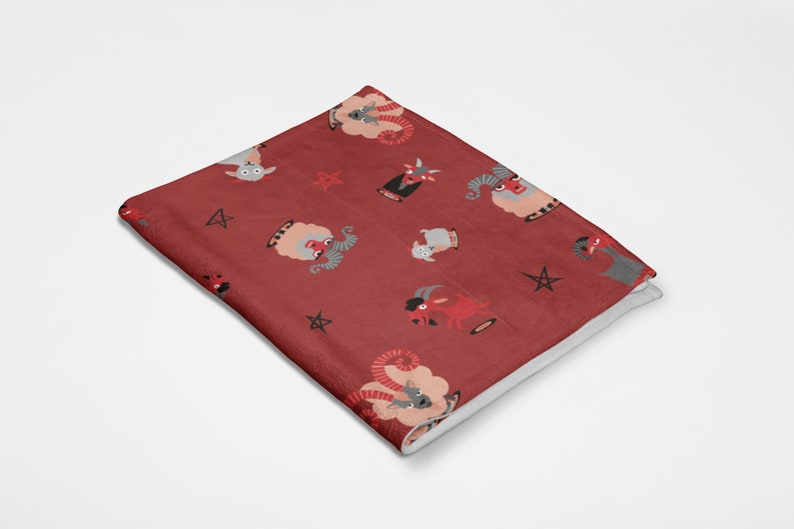 May include: Red fleece throw blanket with a repeating pattern of gray and red goats, pentagrams, and horns.