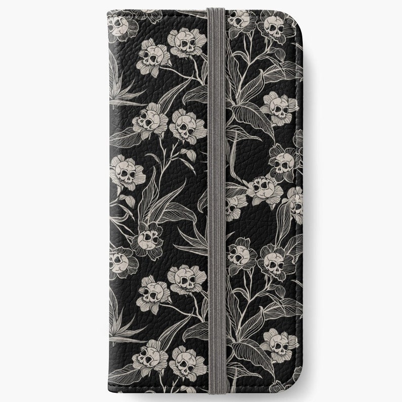 May include: Black leather phone case with a white floral pattern featuring skulls in the centre of each flower.