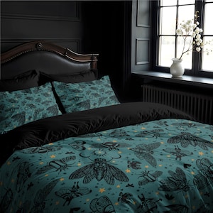 May include: A teal and black bedding set with a pattern of moths, stars, and other insects. The bedding is made of soft, comfortable fabric and is perfect for adding a touch of whimsy to any bedroom.