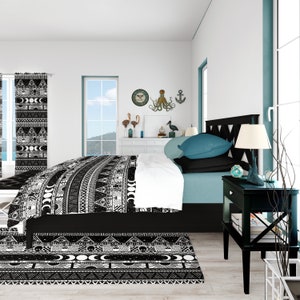May include: Black and white patterned bedding with a geometric design. The bedding is on a bed with a teal headboard and a black nightstand with a lamp. The room has a white wall with a clock and a nautical decor.