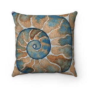 May include: A decorative throw pillow featuring a watercolor painting of a nautilus shell in shades of blue and brown.