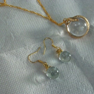 quartz crystal pools of light snake wrapped necklace and earring set rock crystal